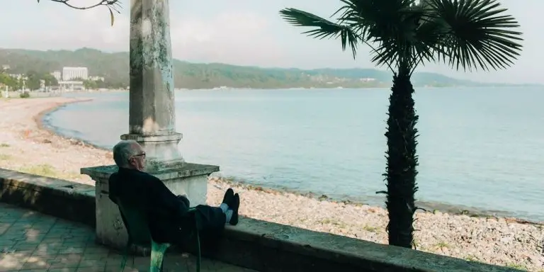 Man sitting by beach thinking